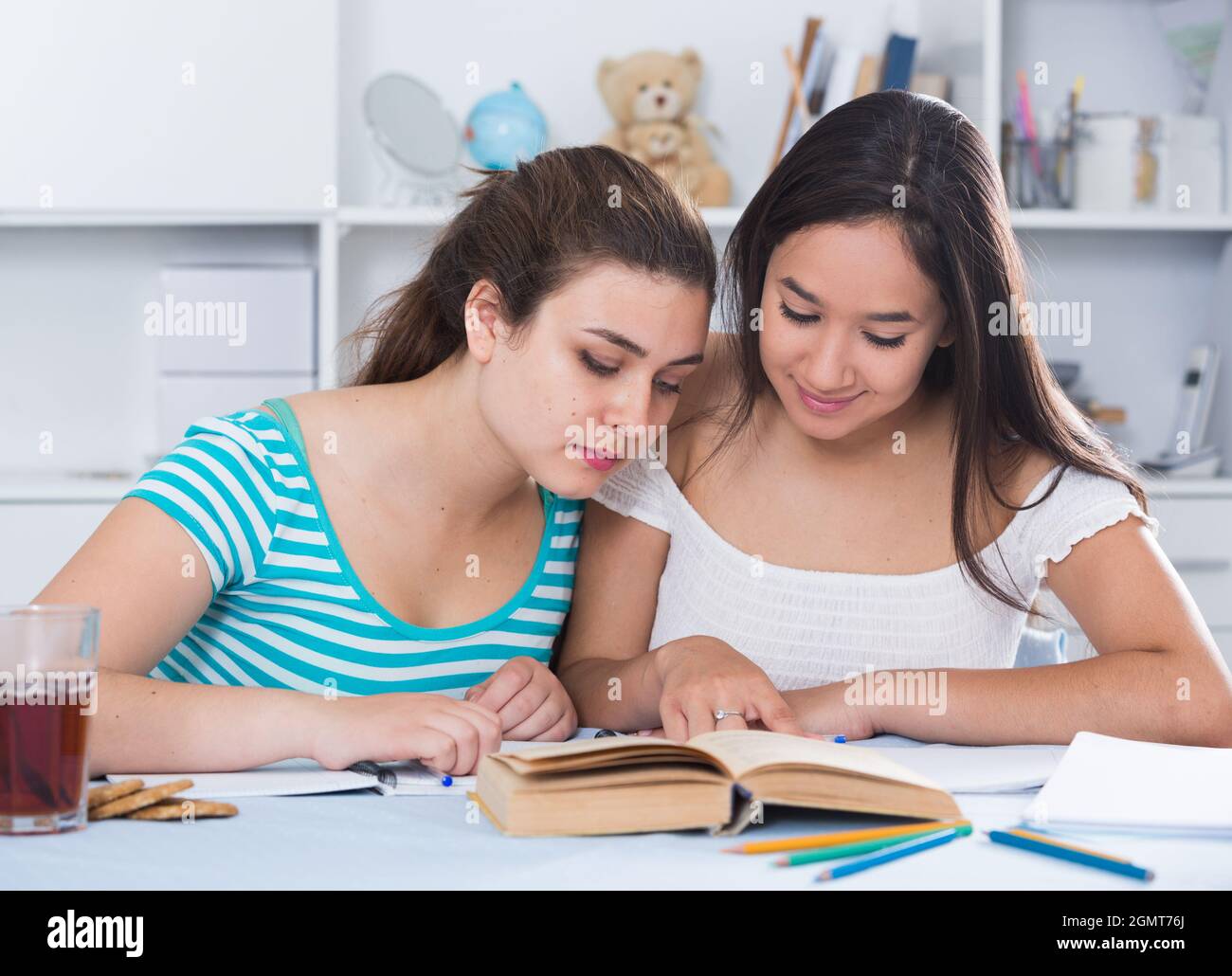 Two classmates doing homework together Stock Photo - Alamy