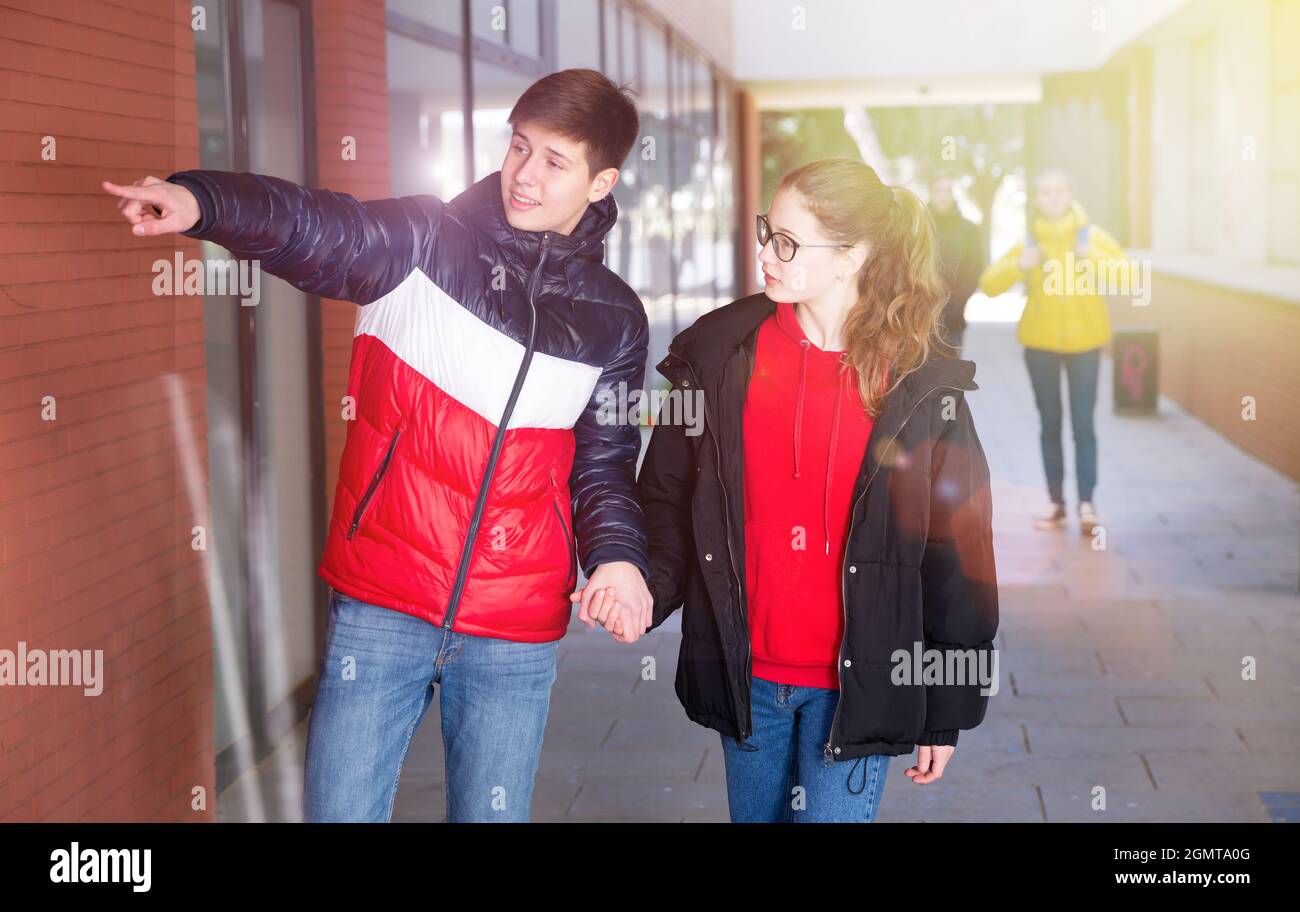 Young pretty couple of student boy and girl together outside happy smiling Stock Photo