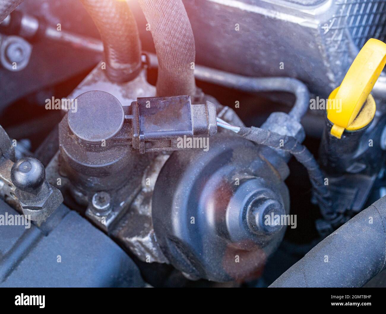 An exhaust gas recirculation valve under the hood of a modern car