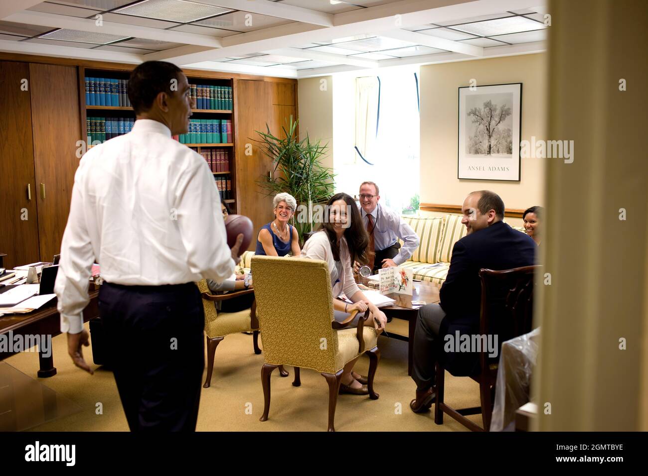 President Barack Obama visits members of the Office of the Staff Secretary,  May 21, 2009.  (Official White House photo by Pete Souza) This official White House photograph is being made available for publication by news organizations and/or for personal use printing by the subject(s) of the photograph. The photograph may not be manipulated in any way or used in materials, advertisements, products, or promotions that in any way suggest approval or endorsement of the President, the First Family, or the White House. Stock Photo