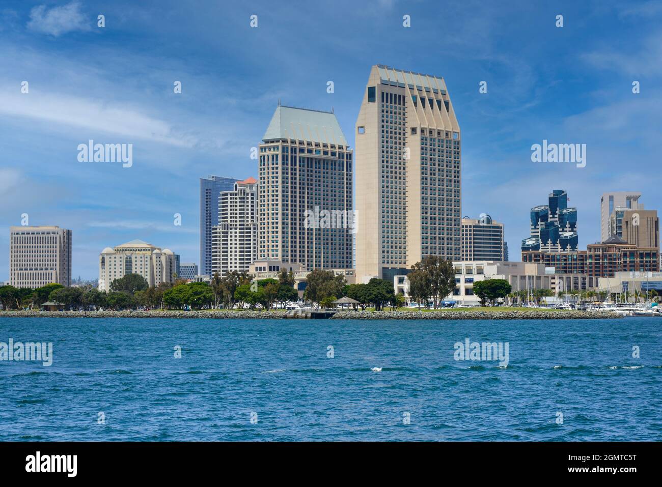 Bay view of stylish Manchester Grand Hyatt San Diego Hotel looming over the Embarcadero Marina Park South on the waterfront by the bay in San Diego,CA Stock Photo