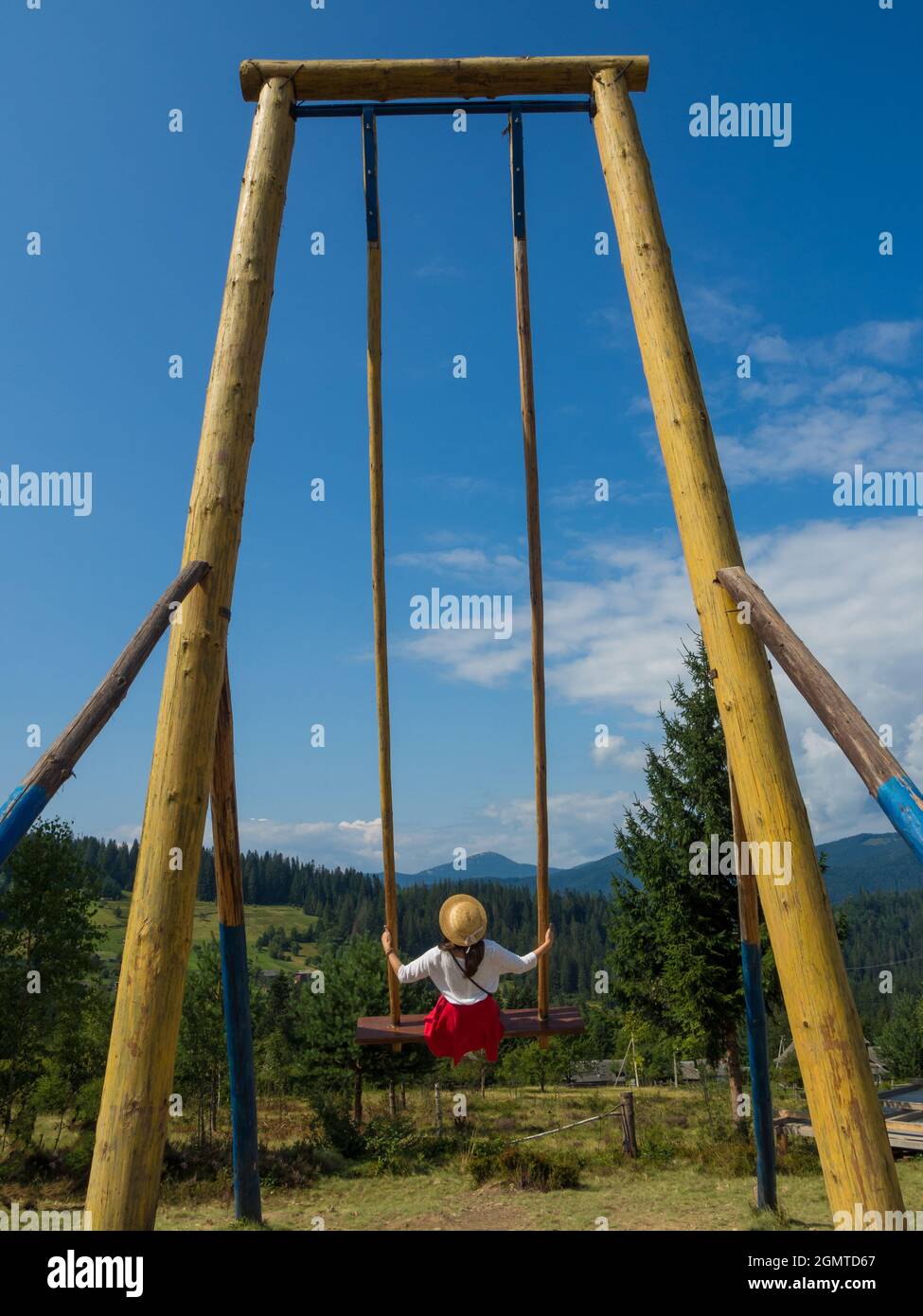 woman traveler enjoying of swinging on heavenly swing and mountain view Stock Photo