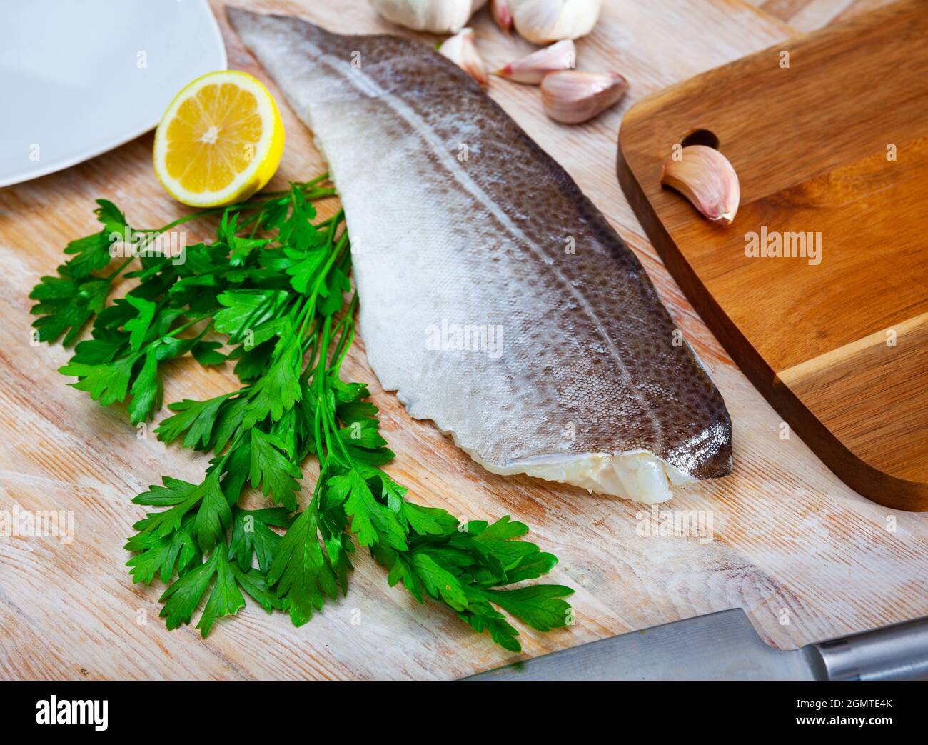 Raw atlantic cod fillet on wooden table Stock Photo - Alamy