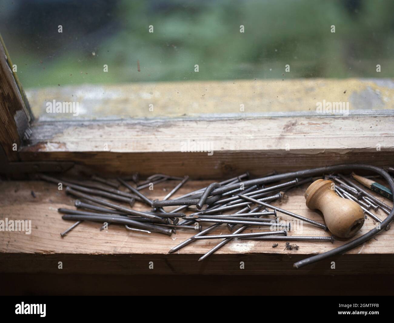 shallow DOF image of a group of nails on a messy window sill Stock Photo Alamy