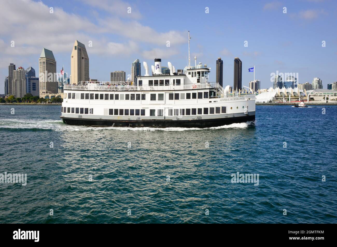 The multi decked Admiral Hornblower ship utilized for San Diego Bay  sightseeing tours & special events cruises by the skyline of San Diego, CA Stock Photo