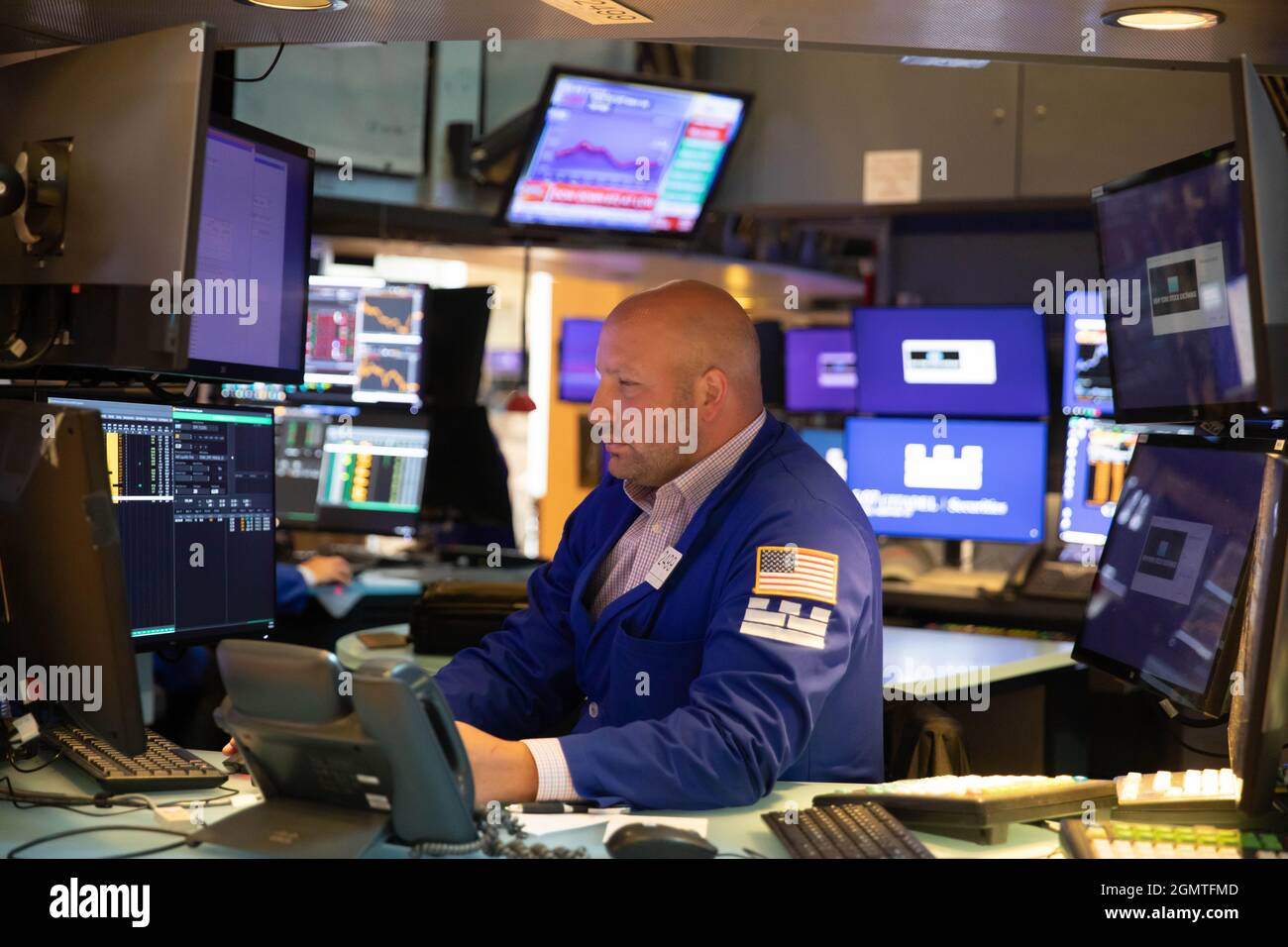 New York, USA. 21st Sep, 2021. A trader works at the trading floor in the New York Stock Exchange in New York, the United States, Sept. 20, 2021. U.S. stocks tumbled on Monday as selling pressure intensified on Wall Street. The Dow Jones Industrial Average fell 614.41 points, or 1.78 percent, to close at 33,970.47, after shedding by more than 970 points at its session low. The S&P 500 dropped 75.26 points, or 1.70 percent, to 4,357.73. The Nasdaq Composite Index slid 330.06 points, or 2.19 percent, to 14,713.90. Credit: Xinhua/Alamy Live News Stock Photo