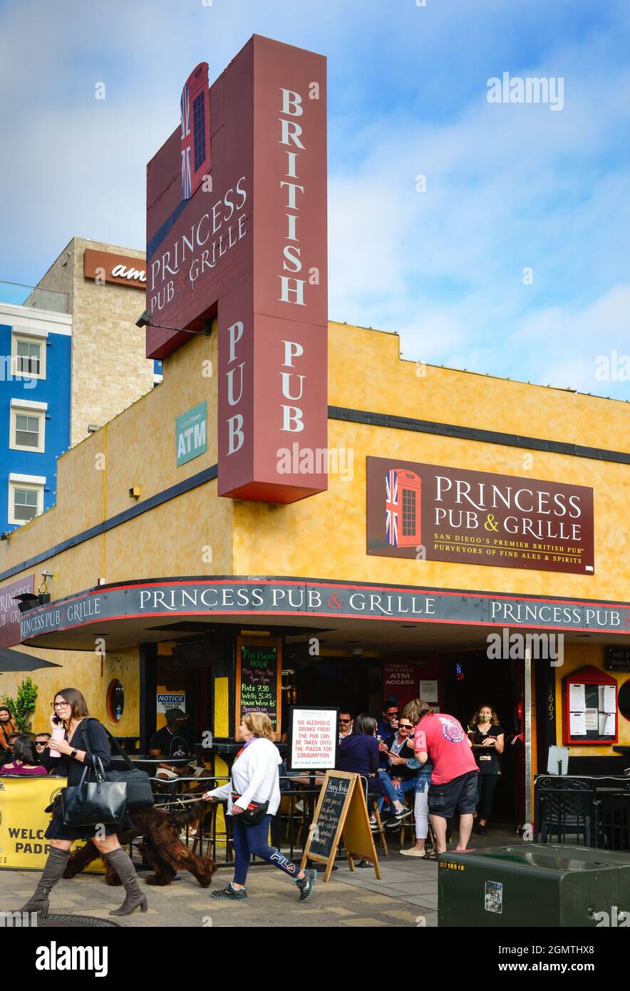 A busy afternoon with people walking by and patrons drinking at the Princess Pub & Grill, A British pub, in Little Italy, San Diego, CA Stock Photo