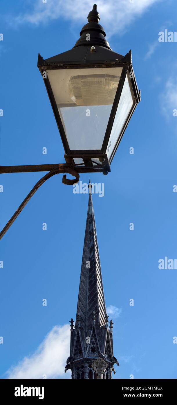 Seen in Ship Street, Oxford - a Victorian lantern seems to be miraculously balanced on a Gothic spire of Exeter College. Stock Photo