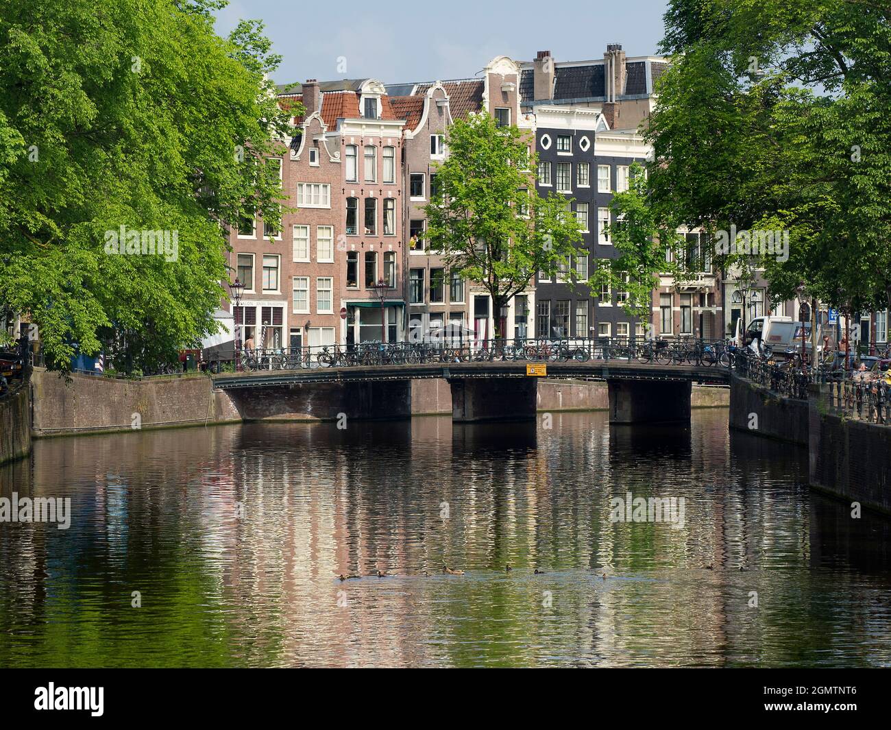 Amsterdam, the Netherlands - 28 May 2016;   Here we see all of AmsterdamÕs archetypes - beautiful canals, gabled houses and the ever present bicycles. Stock Photo