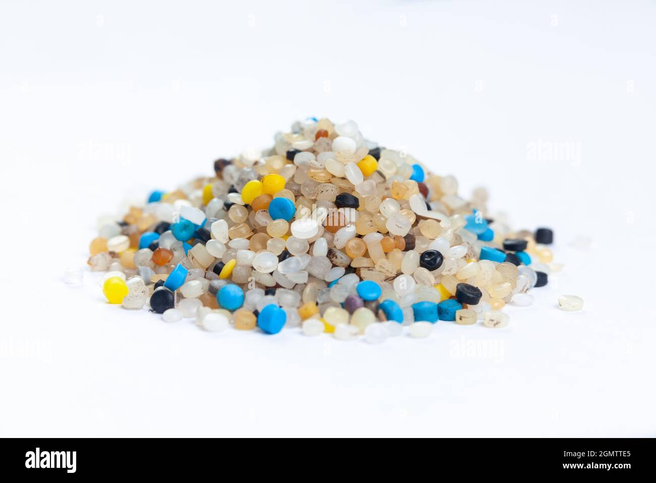 A pile of nurdles collected from the beach on a white background Stock Photo