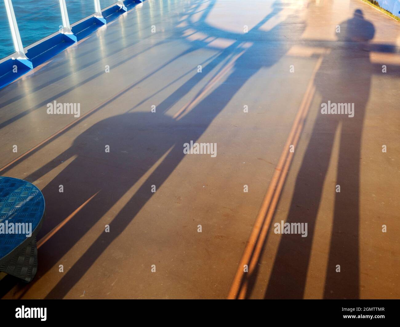 Tasman Sea off New Zealand - 25 February 2019;  long shadows cast on the deck of an ocean liner, cruising in the Tasman Sea just after sunrise. Stock Photo