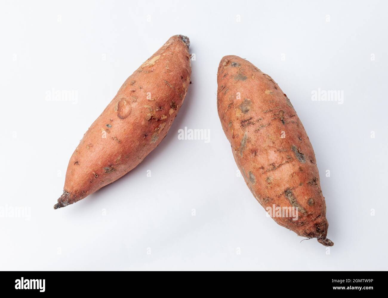 Two sweet potatoes on a white background Stock Photo