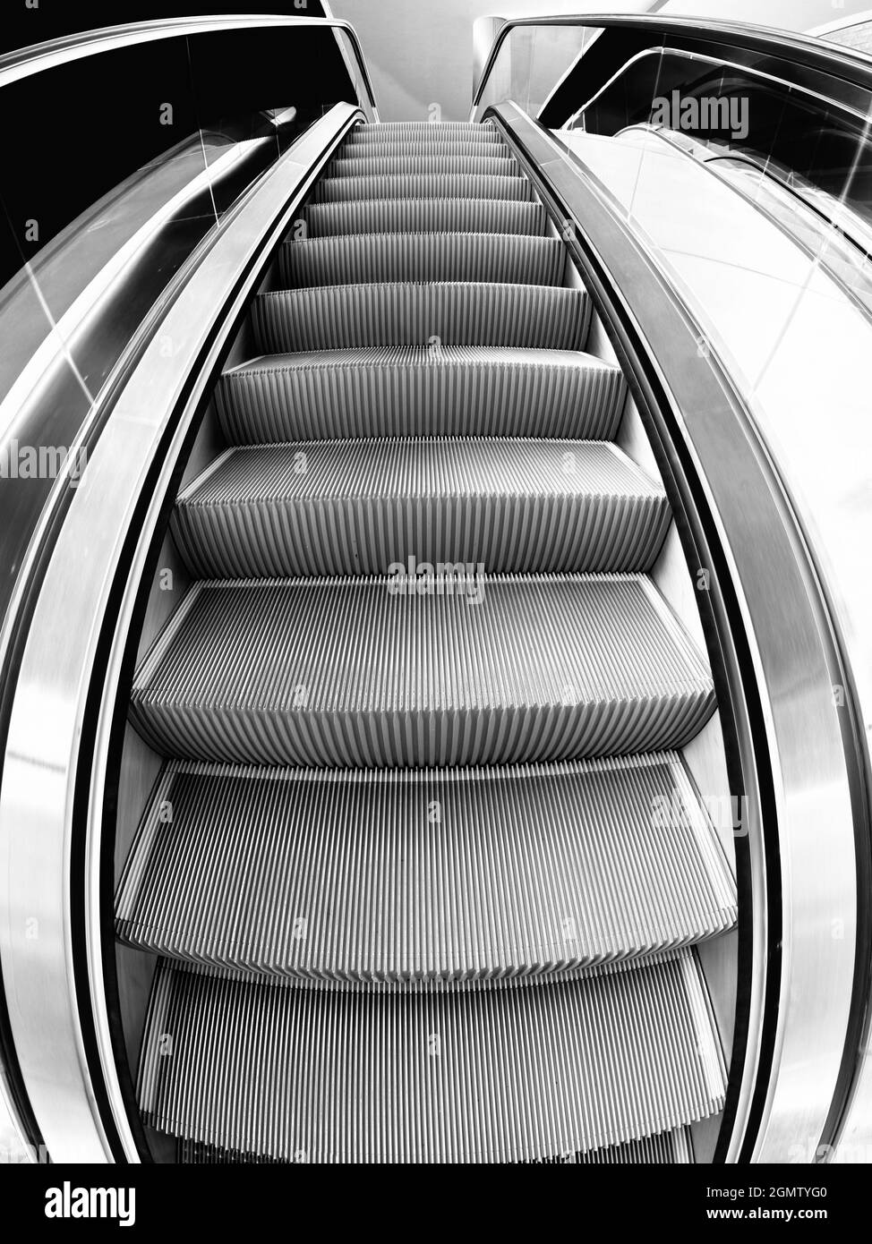 Curved escalator in a shopping mall Black and White Stock Photos ...