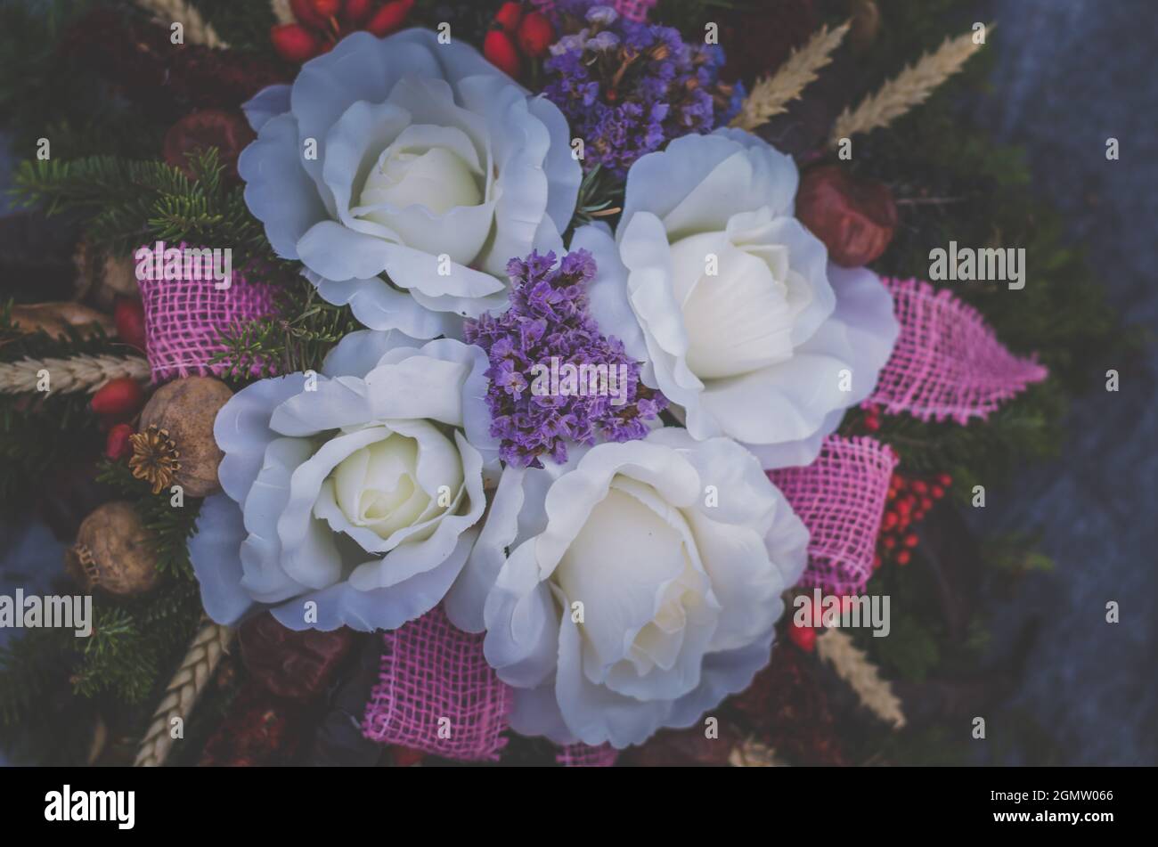 colorful floral decoration of flowers on graves in cemetery during All