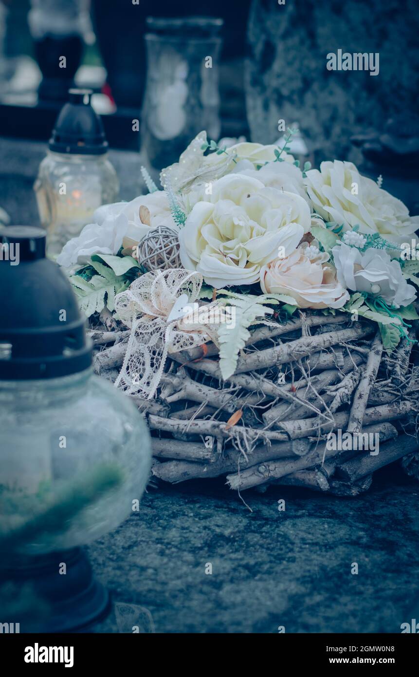 colorful symbolic decoration of flowers on graves in cemetery during