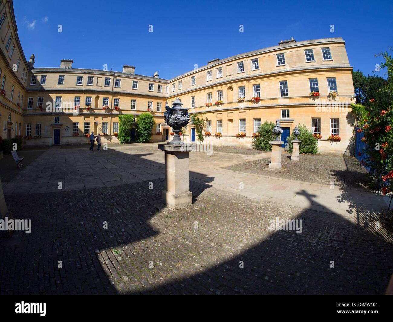 Oxford, England - 20 September 2013; two people in view. The garden Quadrangle of Trinity College of Oxford University, England.This relatively large Stock Photo