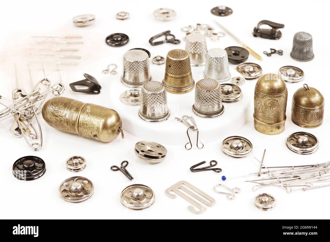 Metal objects for sewing: needles, thimbles, fasteners, buttons, hooks, pins Stock Photo