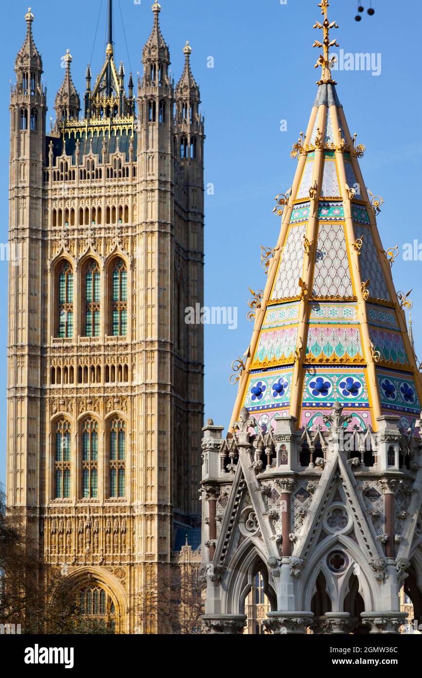 Despite looking so different, the colourful gazebo of the Buxton Memorial in the foreground, together with the Victoria Tower of the Houses of Parliam Stock Photo