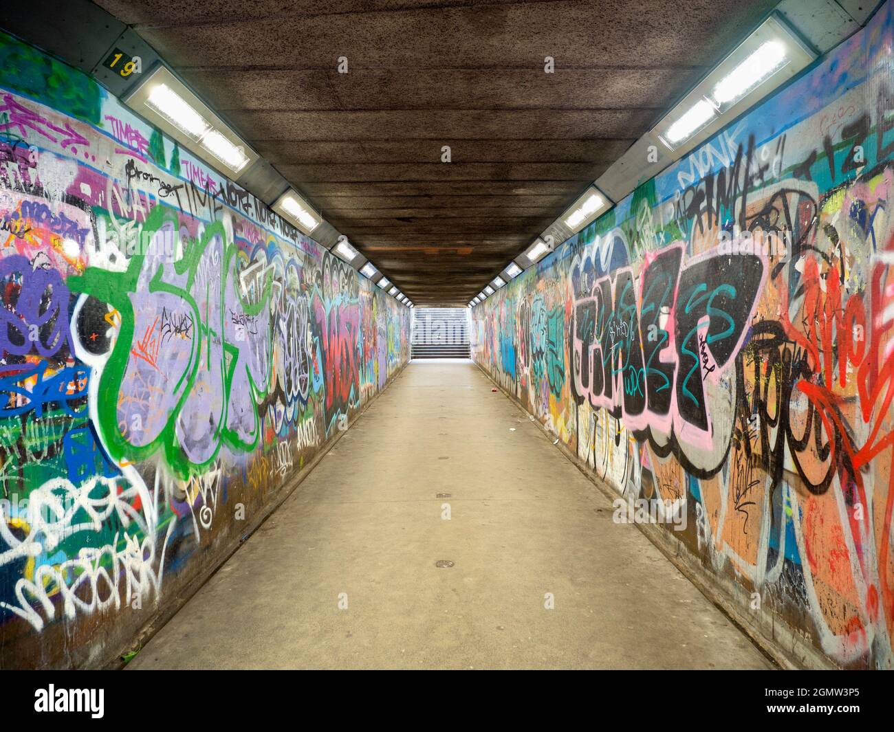 Subways in many cities are places that are dark and dangerous. But here we see one in Belfast that has been transformed by vivid, colourful graffiti i Stock Photo