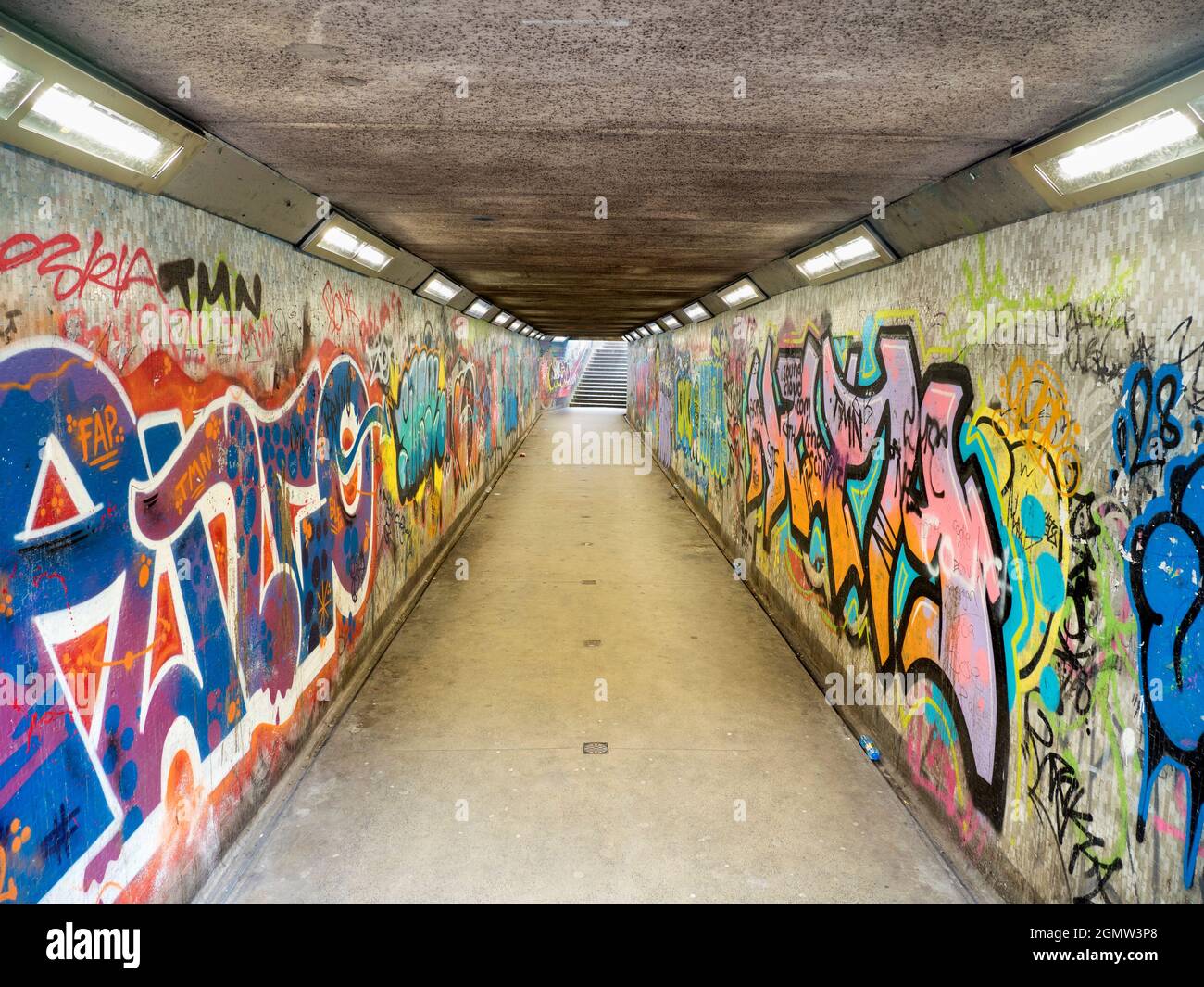 Subways in many cities are places that are dark and dangerous. But here we see one in Belfast that has been transformed by vivid, colourful graffiti i Stock Photo