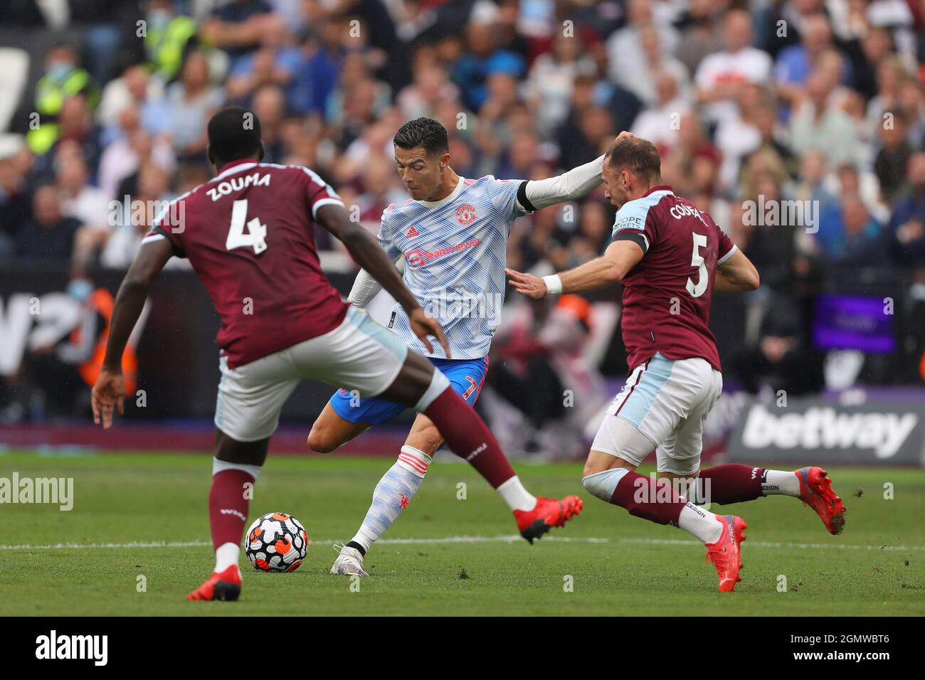 Cristiano Ronaldo of Manchester United in action with Vladimir Coufal and Kurt Zouma of West Ham United - West Ham United v Manchester United, Premier League, London Stadium, London, UK - 19th September 2021  Editorial Use Only - DataCo restrictions apply Stock Photo