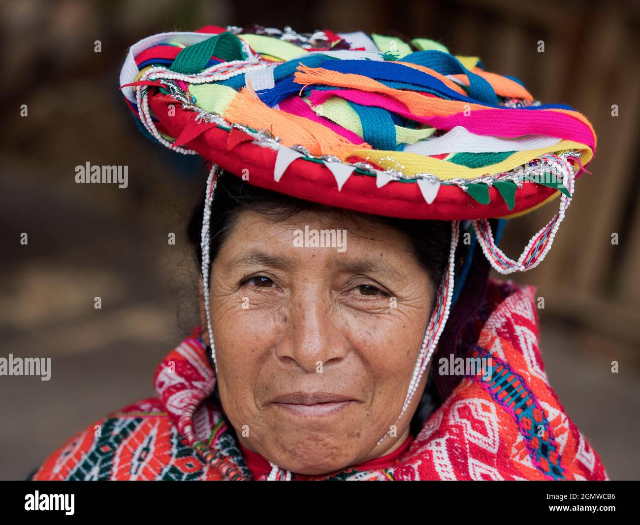 Awanakancha, Peru - 11 May 2018; one woman in shot   Portrait of a weaver in Awanakancha, wearing colorful traditional tribal costume. Stock Photo