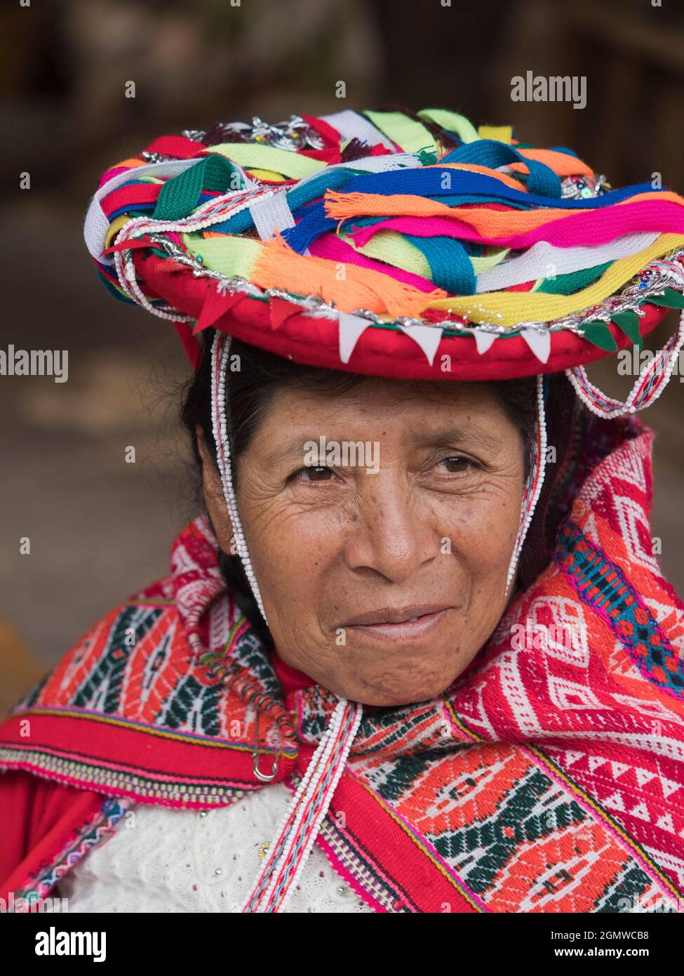Awanakancha, Peru - 11 May 2018; one woman in shot   Portrait of a weaver in Awanakancha, wearing colorful traditional tribal costume. Stock Photo