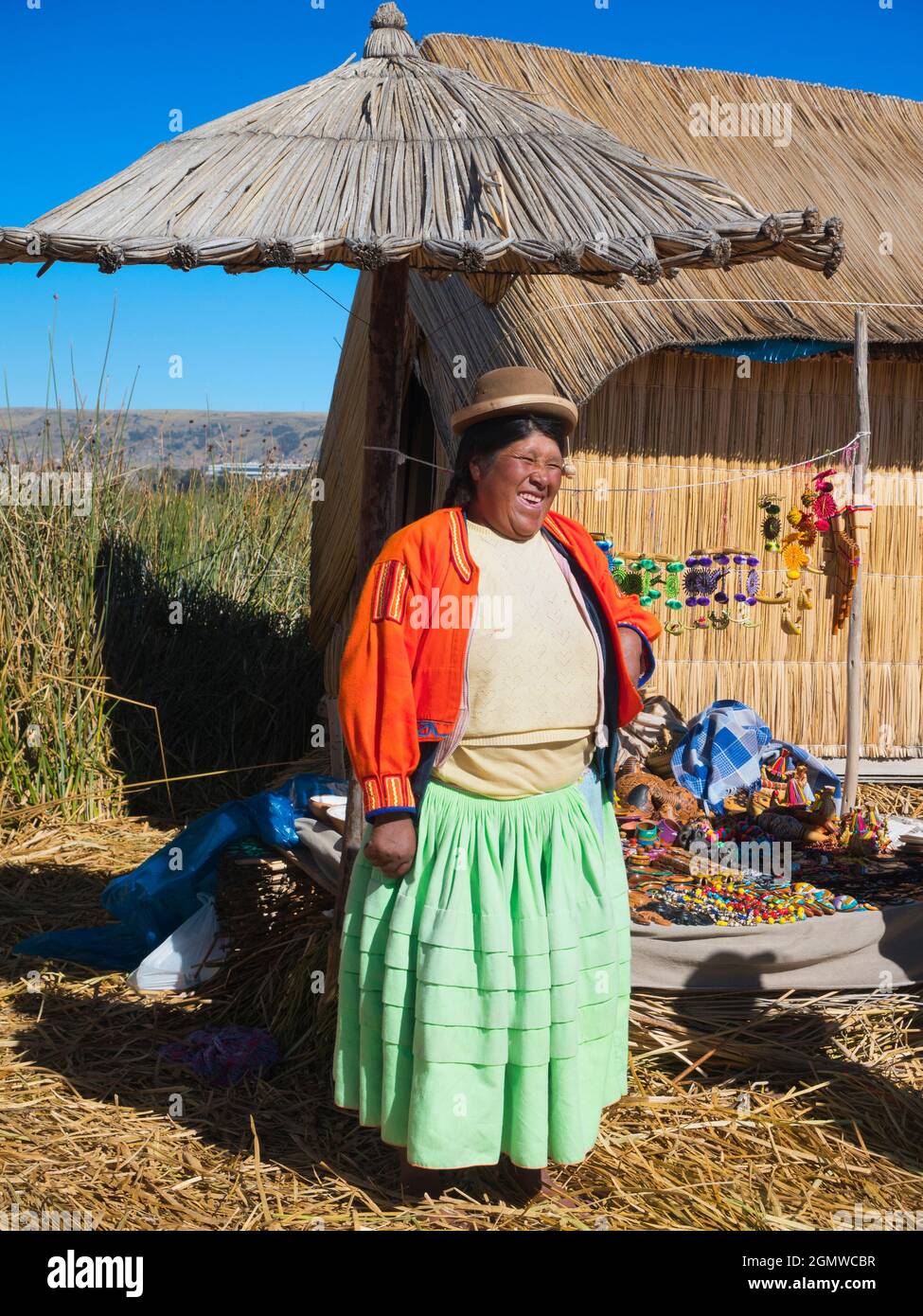 Lake Titicaca, Peru - 17 May 2018; one native person in shot   Situated at 3,812 metres (12,507 ft) elevation, the beautiful, jewel-like Lake Titicaca Stock Photo