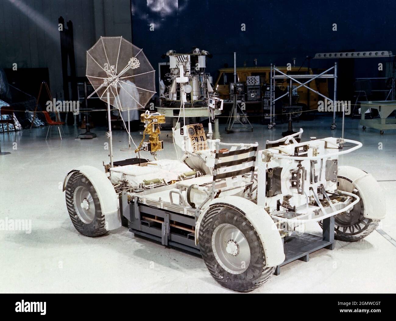 The Lunar Roving Vehicle (LRV) was designed to transport astronauts and materials on the Moon. It was a collapsible open-space vehicle about 10 feet long with large mesh wheels, anterna, appendages, tool caddies, and cameras. Powered by two 36-volt batteries, it has four 1/4-hp drive motors, one for each wheel. The vehicle was designed to travel in forward or reverse, negotiate obstacles about 1 foot high, cross crevasses about 2 feet wide, and climb or descend moderate slopes. Its speed limit was about 9 miles (14 kilometers) per hour. An LRV was used on each of the last three Apollo missions Stock Photo