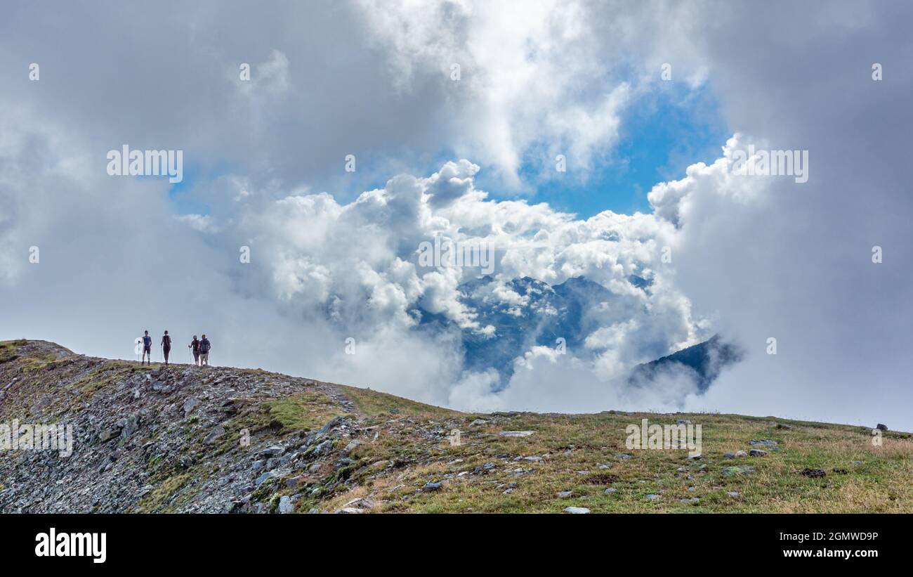 Group of hikers on top of a hill under the beautiful cloudy sky Stock ...
