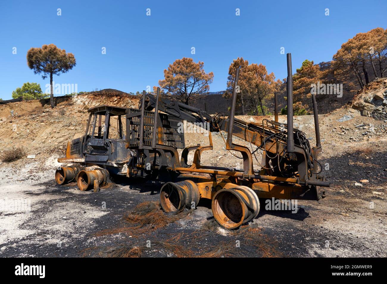 Heavy machinery burned by fire in the Jubrique fire next to Sierra Bermaja in the Genal Valley, Malaga. Andalusia, Spain. September 2021 Stock Photo