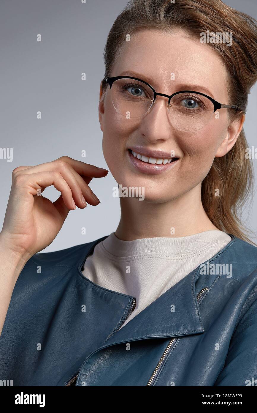 Portrait of nice adorable slim sweet lovely gorgeous attractive winsome cheerful clever smart intelligent wavy-haired lady touching glasses isolated o Stock Photo