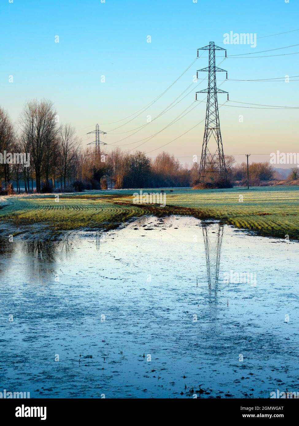 Oxfordshire, England -  27  February 2021; no people in view.    I love electricity pylons; I find their abstract, gaunt shapes endlessly fascinating. Stock Photo