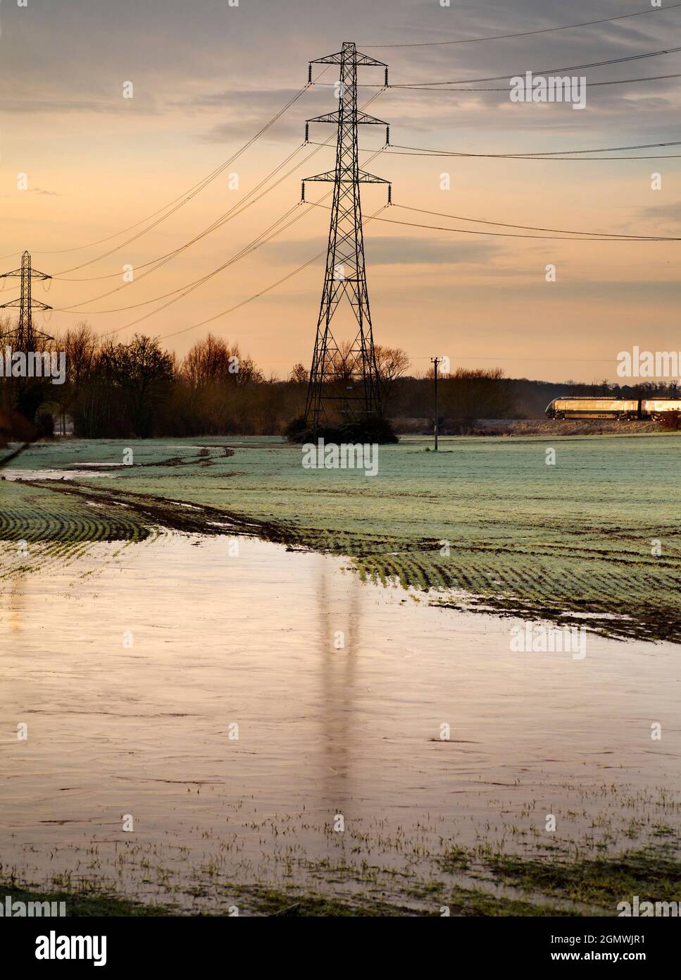 Oxfordshire, England -  30 December 2020; no people in view.    I love electricity pylons; I find their abstract, gaunt shapes endlessly fascinating. Stock Photo