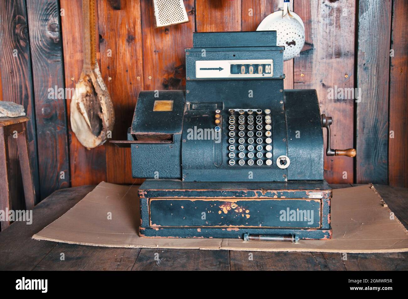 Old vintage calculating machine against wooden background Stock Photo