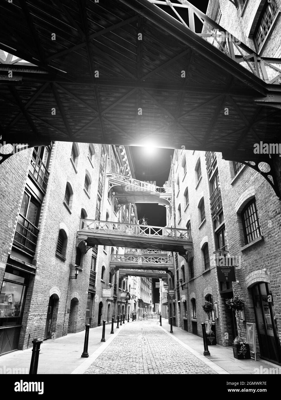 Shad Thames is now the best surviving example of a type of commercial street that was common in London Dockland before its gentrification and developm Stock Photo