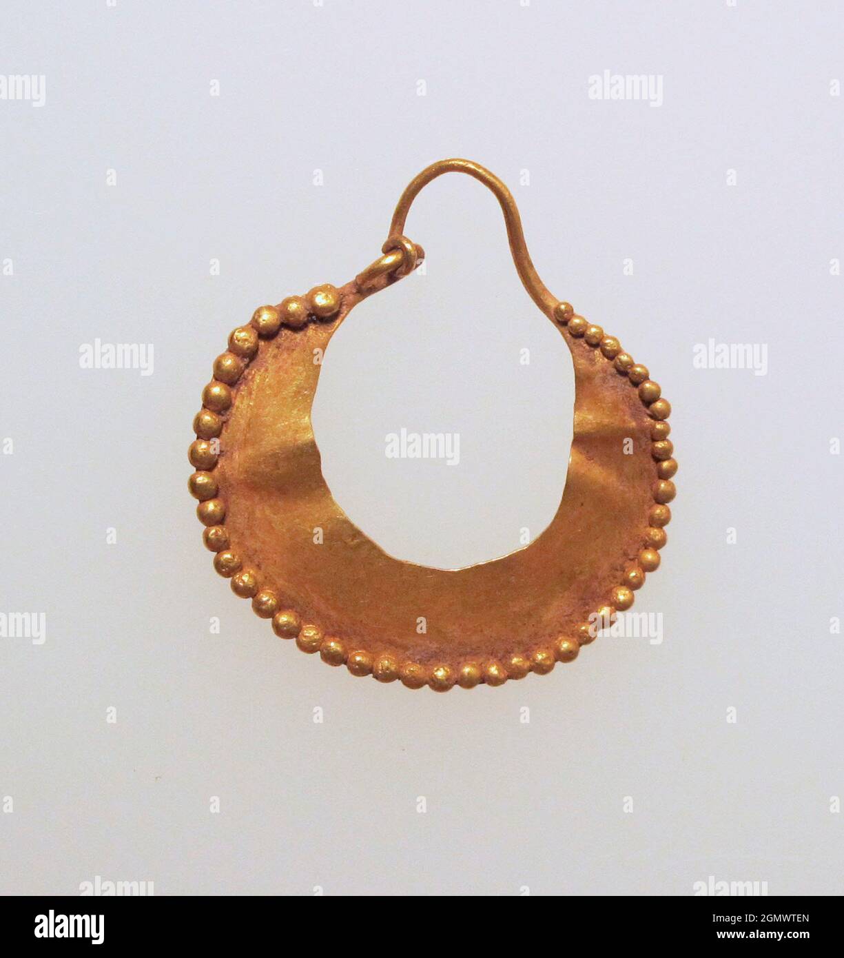 Earring, crescent-shaped. Medium: Gold; Dimensions: Other: 7/8 x 15/16 x 1/16 in. (2.2 x 2.4 x 0.1 cm); Classification: Gold and Silver Stock Photo
