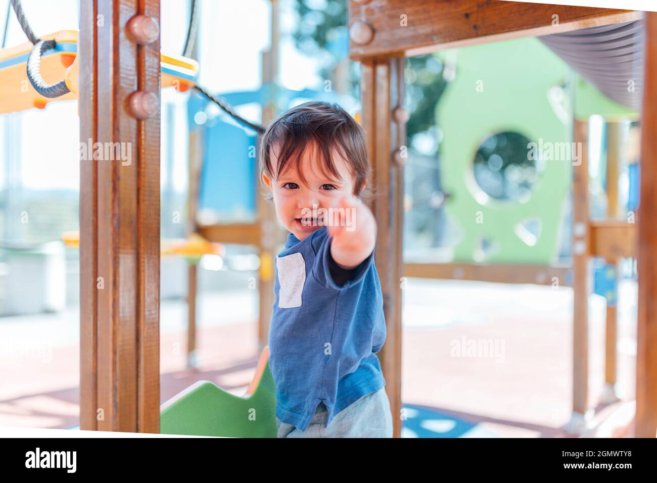 one year old baby in a play park pointing fingers in front Stock Photo ...