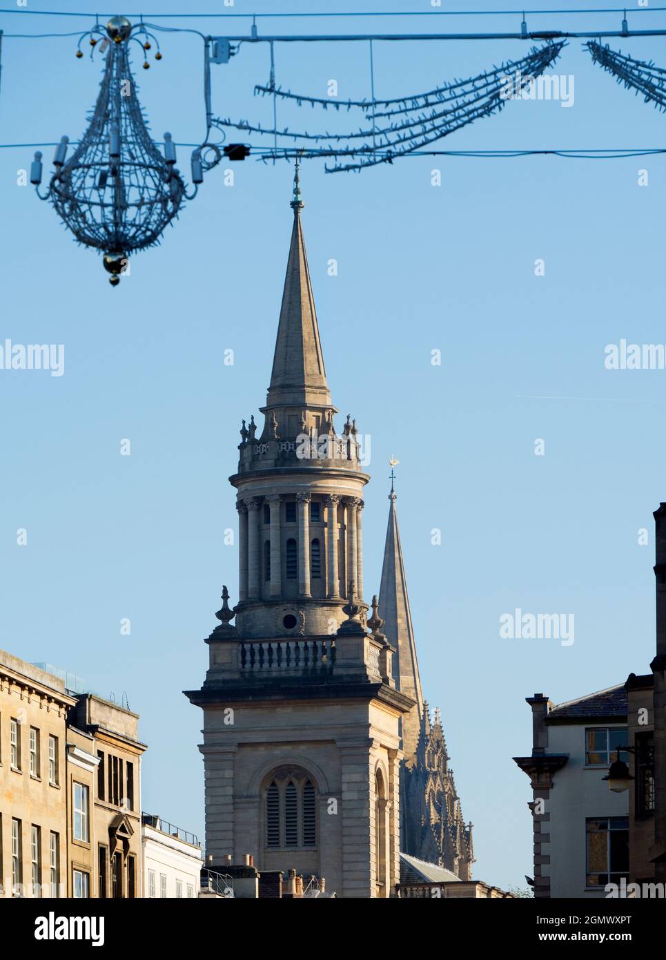 Oxford, England - 6 November 2017 Christmas decorations in Oxford High Street, with some of the city's famous dreaming spires in the background. We se Stock Photo
