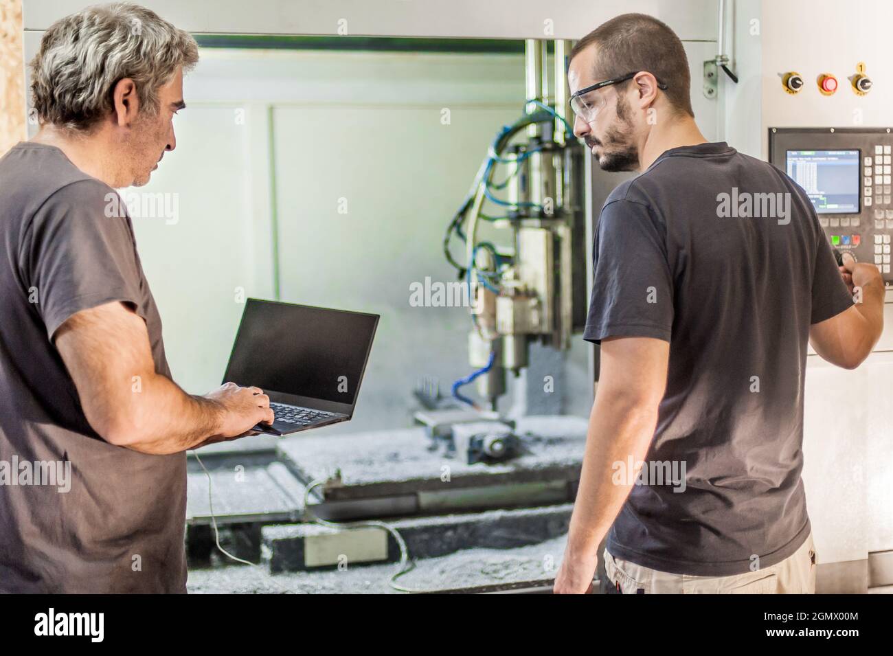 Two field service maintenance engineer technician electrician inspect