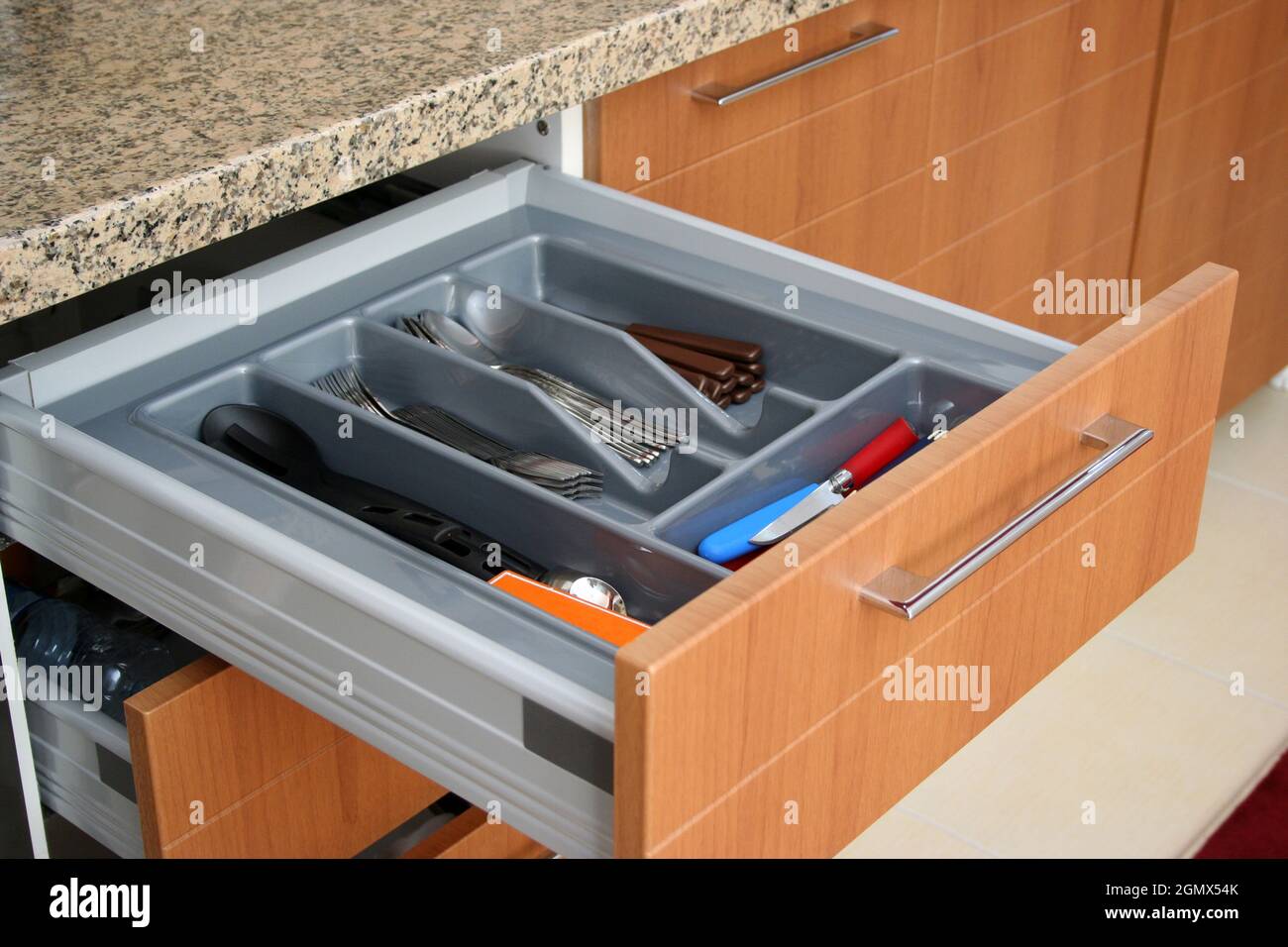 Forks, spoons, knives in the sliding drawer. Sliding kitchen drawers