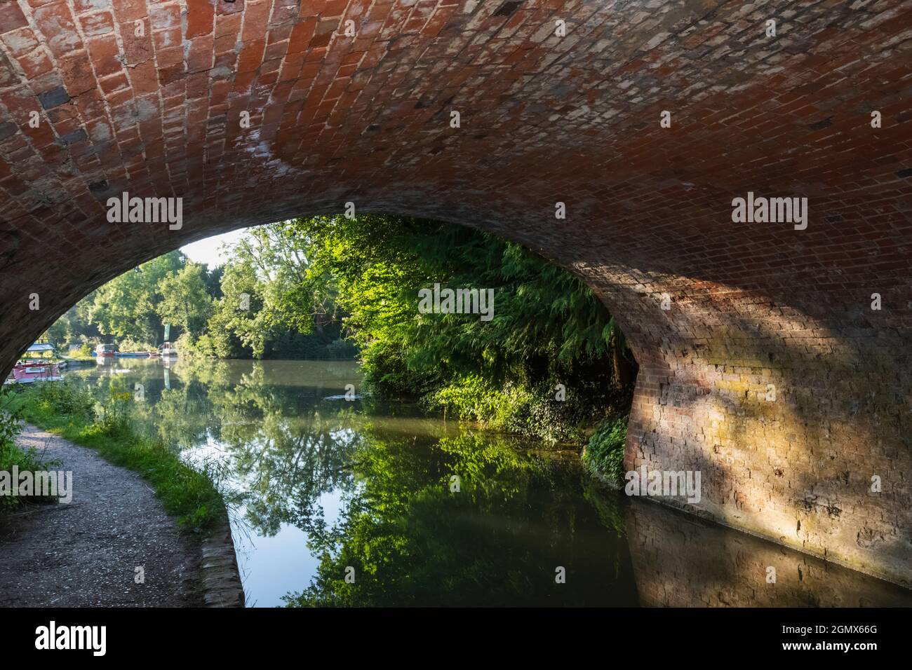 England, Hampshire, Basingstoke, Odiham, Basingstoke Canal, Canoeist under  Bridge Stock Photo