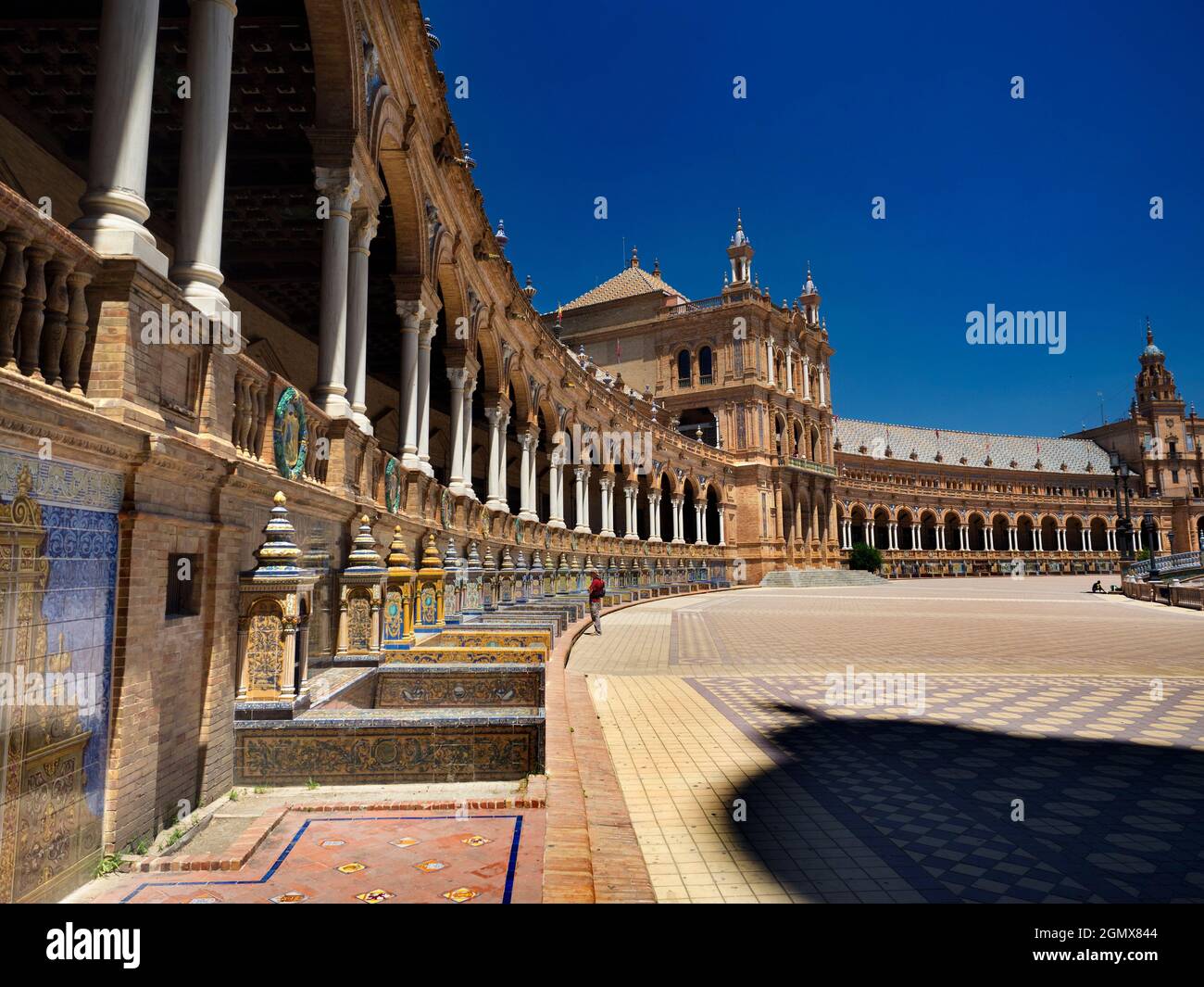Seville, Andalucia, Spain - 31 May 2016; two people in view. Located in the Parque de Mar’a Luisa in Seville, Spain, the grandiose Plaza de Espa–a was Stock Photo