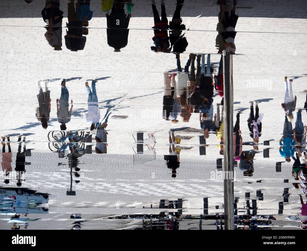 Marseilles, France - 20 June 2013; Lots of people in view, but upside down.The Ombriere in Marseilles Old Port is a blade of reflective stainless stee Stock Photo