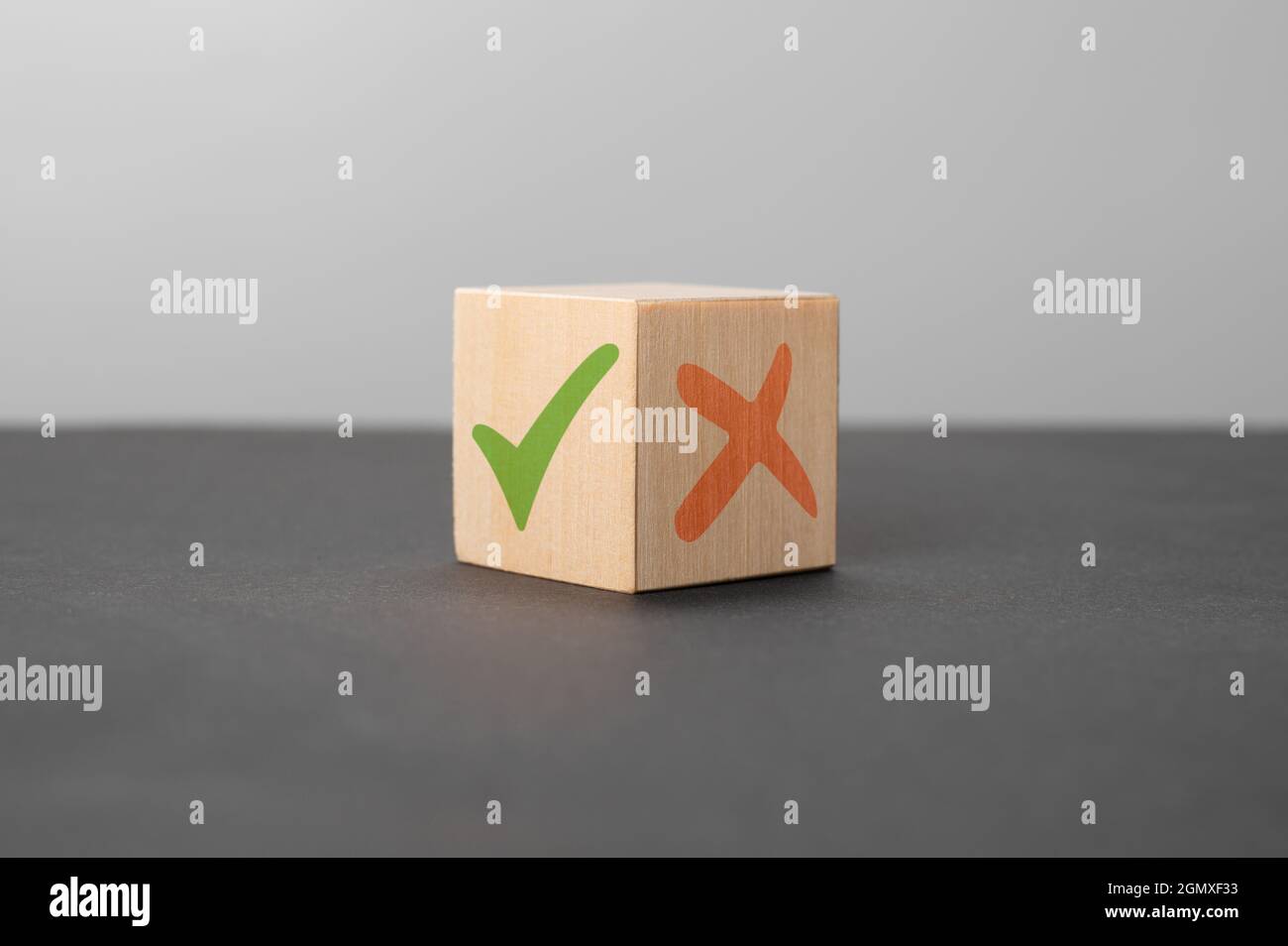 pros and cons concept. Wooden cube with image of pros versus cons. Concept of positive or negative decision making or choice of approval or rejection. Stock Photo
