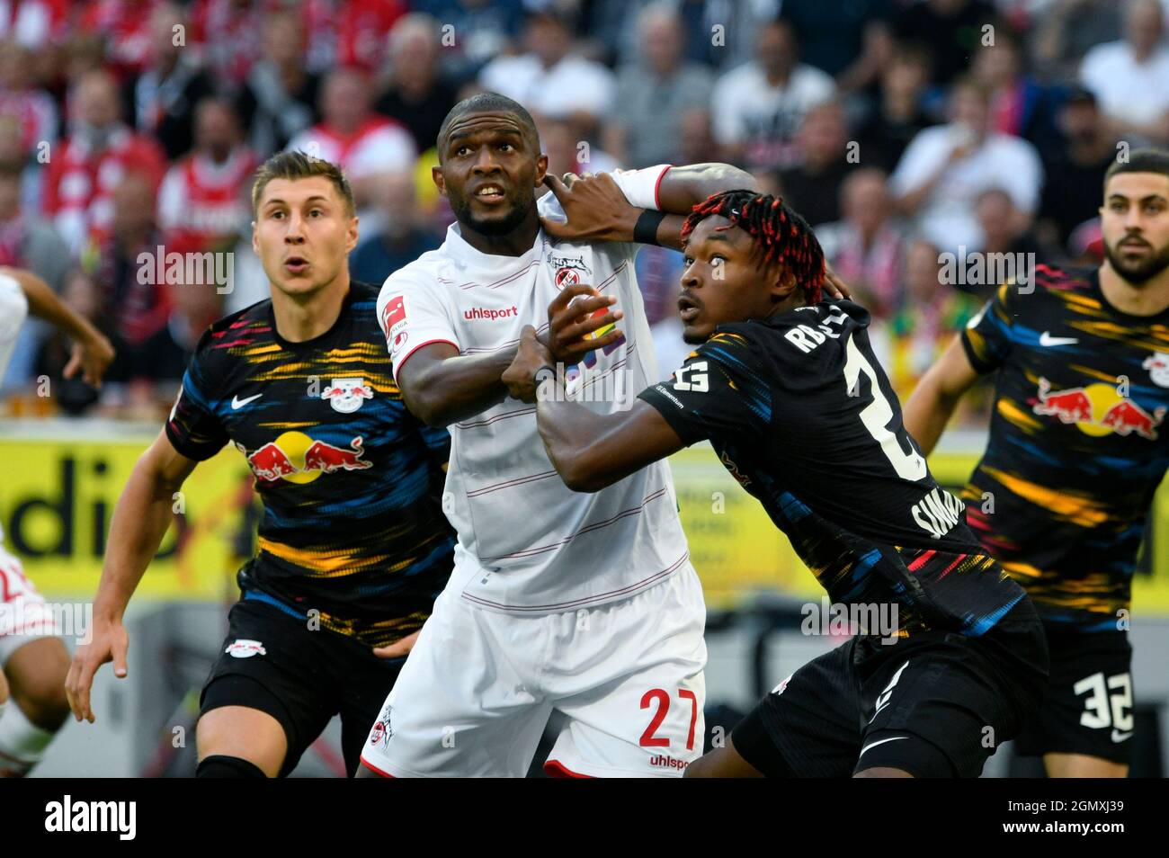 RheinEnergieStadion Cologne Germany,  18.9.2021 Football:  Bundesliga Season 2021/22, matchday 5, 1.FC Koeln (KOE) vs Rasenballsport Leipzig (RBL)  — from left:Dani Olmo (RBL), Anthony Modeste (KOE), Mohamed Simakan (RBL)   DFL REGULATIONS PROHIBIT ANY USE OF PHOTOGRAPHS AS IMAGE SEQUENCES AND/OR QUASI-VIDEO Stock Photo