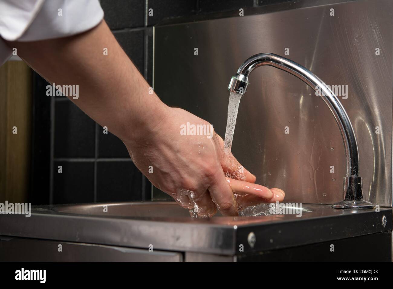 Close up photo of Men washing hands with water Stock Photo - Alamy