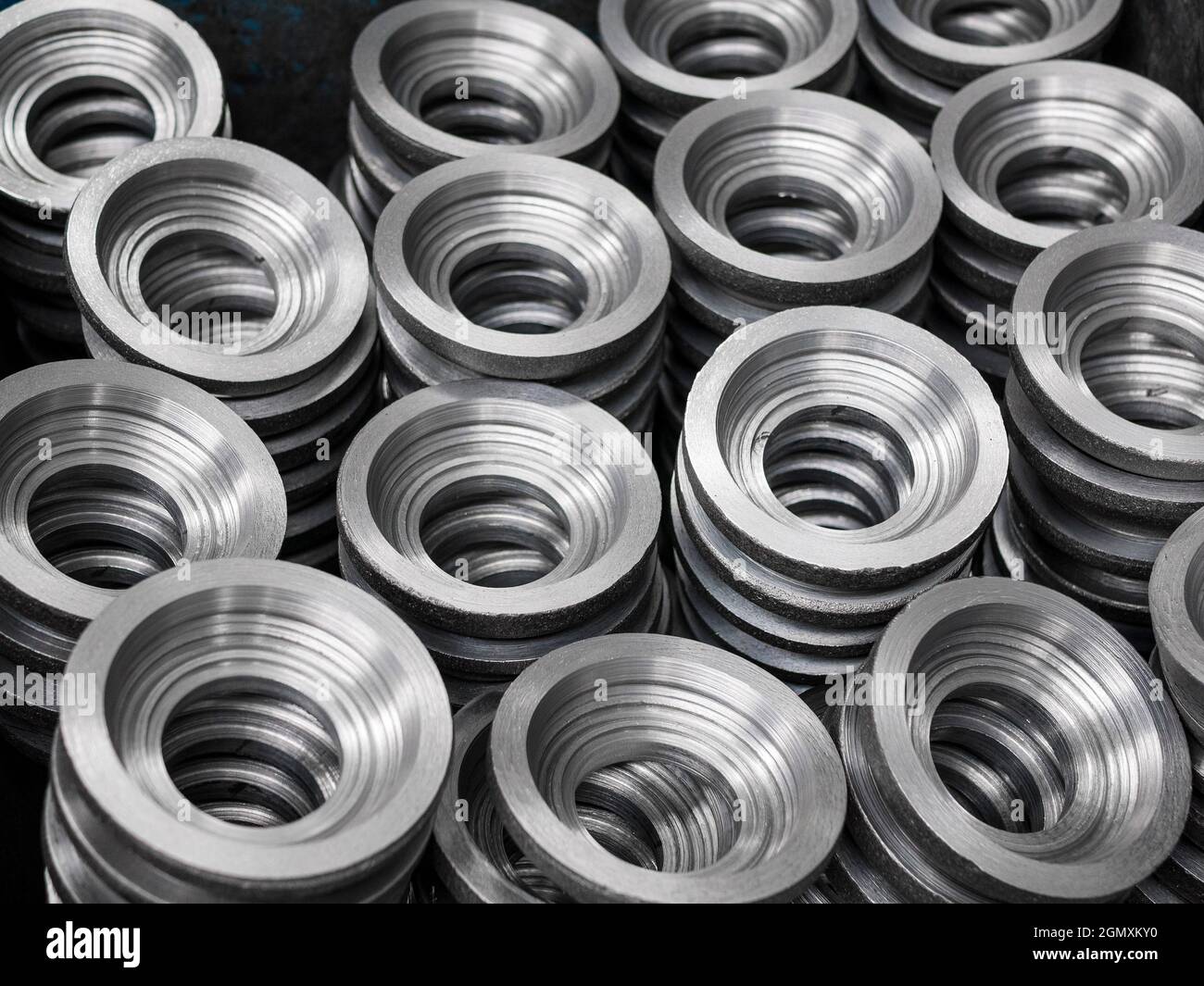 Piles of the gear blanks with bore, close up. Manufacturing of cylindrical gears Stock Photo