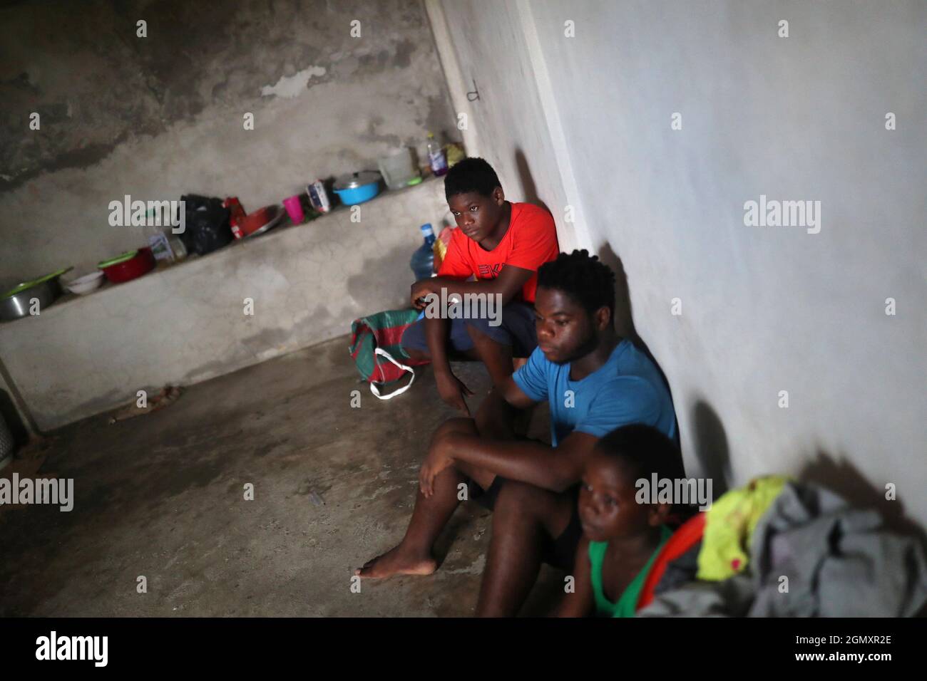 Migrants from Haiti rest inside a room as thousands of migrants arrive at the southern border with Guatemala and the U.S. border en masse, in Tapachula, Chiapas state, Mexico September 16, 2021. Picture taken September 16, 2021. REUTERS/Edgard Garrido Stock Photo