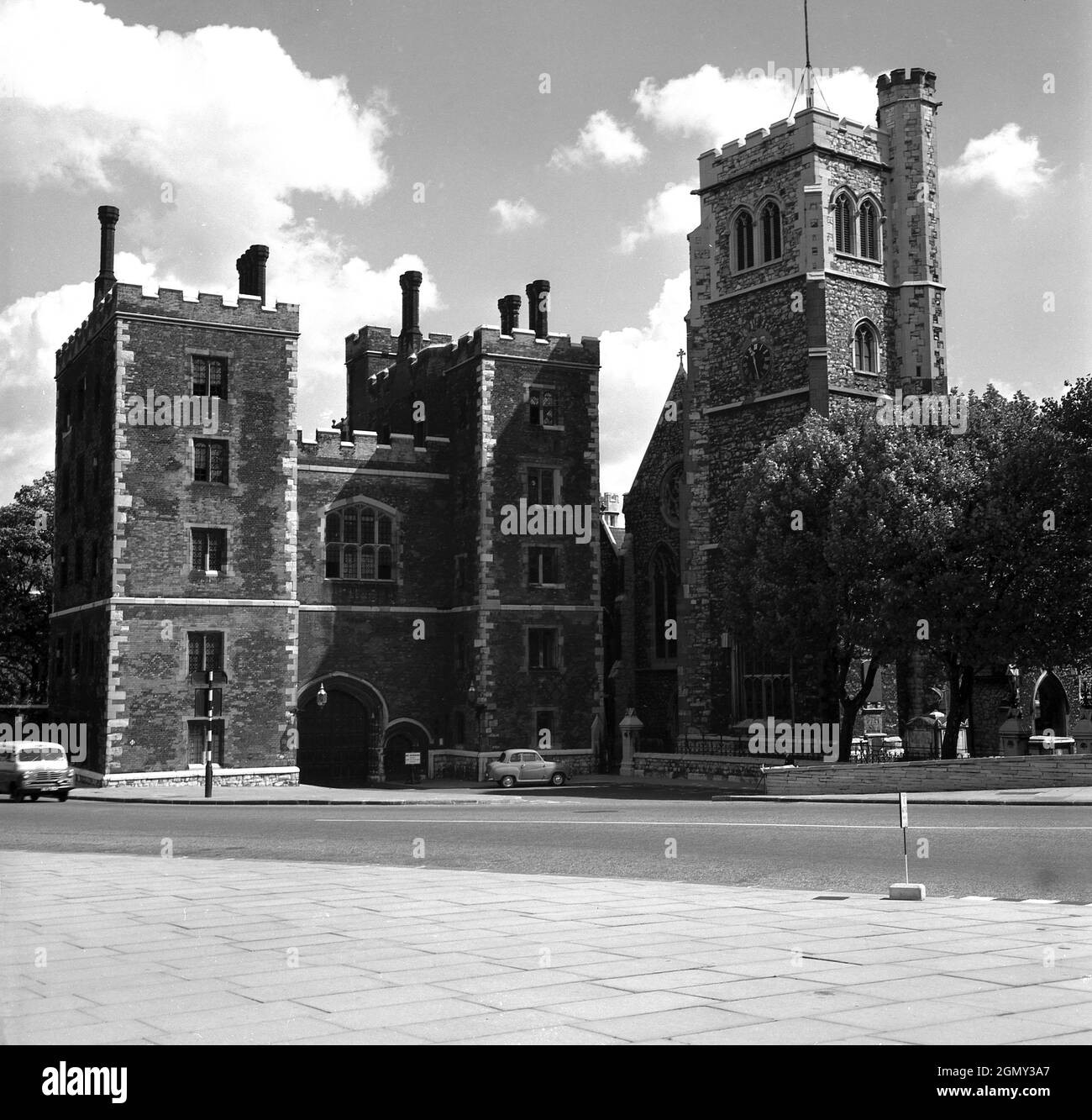 1950s, historical picture from this era of Lambeth Palace, London, England, UK, the official London residence of the Archbishop of Canterbury, as seen from Lambeth Road. Originally known as Lambeth House, the building was acquired by the Diocese circa AD 1200. Seen here covered in black soot is the Tudor brick gatehouse built by Cardinal John Morton. Stock Photo